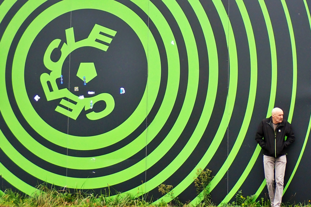George in front of a large Cercle Brugge logo